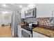 Updated kitchen with stainless steel appliances and granite countertops at 3311 S Atlantic Ave # 304, Daytona Beach Shores, FL 32118