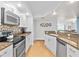 Modern kitchen with granite countertops, stainless steel appliances, and tile floors at 3311 S Atlantic Ave # 304, Daytona Beach Shores, FL 32118