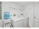 Bright laundry room with washer, dryer, and water dispenser at 3311 S Atlantic Ave # 304, Daytona Beach Shores, FL 32118