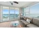 Living area features ocean views, balcony access, and a ceiling fan at 3311 S Atlantic Ave # 304, Daytona Beach Shores, FL 32118