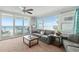Living room boasts ocean views, sliding doors to balcony, and comfy seating at 3311 S Atlantic Ave # 304, Daytona Beach Shores, FL 32118