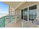 Balcony with partial ocean view and patio furniture at 3311 S Atlantic Ave # 304, Daytona Beach Shores, FL 32118