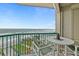 Balcony with ocean view, table and chairs, and relaxing lounge chair at 3311 S Atlantic Ave # 304, Daytona Beach Shores, FL 32118