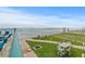 Peaceful ocean view patio with seating area and manicured lawn at 3311 S Atlantic Ave # 304, Daytona Beach Shores, FL 32118