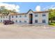 Tan colored building exterior with parking lot and landscaping at 415 Banana Cay Dr # F, South Daytona, FL 32119