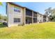 Building exterior showcasing multiple units and lush landscaping at 415 Banana Cay Dr # F, South Daytona, FL 32119