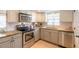 Bright kitchen with granite counters and stainless steel appliances at 415 Banana Cay Dr # F, South Daytona, FL 32119