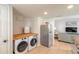 Stackable washer and dryer in a small laundry room at 415 Banana Cay Dr # F, South Daytona, FL 32119