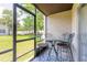 Relaxing screened patio with table and chairs, perfect for outdoor dining at 415 Banana Cay Dr # F, South Daytona, FL 32119