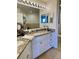 Elegant bathroom boasts a double vanity with granite countertops at 5300 S Atlantic Ave # 19-502, New Smyrna Beach, FL 32169