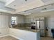 Community kitchen with stainless steel appliances and granite countertop at 5300 S Atlantic Ave # 19-502, New Smyrna Beach, FL 32169