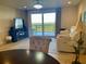 Spacious living room with large windows offering scenic views at 5300 S Atlantic Ave # 19-502, New Smyrna Beach, FL 32169