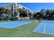 Two well-maintained outdoor tennis courts at 5300 S Atlantic Ave # 19-502, New Smyrna Beach, FL 32169