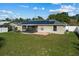 Large backyard with solar panels and screened patio at 552 Nardello Dr, Deltona, FL 32725