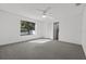 Large bedroom with ceiling fan, window, and grey carpet at 552 Nardello Dr, Deltona, FL 32725