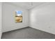 Bright bedroom with window, ceiling fan, and grey carpet at 552 Nardello Dr, Deltona, FL 32725