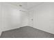 Bright bedroom with grey carpeting, double door closet, and neutral walls at 552 Nardello Dr, Deltona, FL 32725