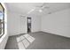 Spacious bedroom with ceiling fan, grey carpet and private bathroom access at 552 Nardello Dr, Deltona, FL 32725