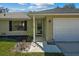 Tan house with a two-car garage, front door, and landscaping at 552 Nardello Dr, Deltona, FL 32725