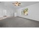 Bright living room featuring a ceiling fan and large window at 552 Nardello Dr, Deltona, FL 32725