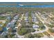 Aerial view showing the house and surrounding neighborhood near the water at 75 Jennifer Cir, Ponce Inlet, FL 32127