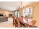 Bright dining room with wood table and chairs, offering views to the living room and kitchen at 75 Jennifer Cir, Ponce Inlet, FL 32127