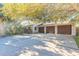 House exterior featuring a three-car garage and mature landscaping at 75 Jennifer Cir, Ponce Inlet, FL 32127