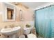 Simple bathroom with a white sink, toilet, and shower at 1010 W New York Ave, Orange City, FL 32763