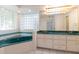 Bathroom with double vanity, corner tub, and a large mirror at 1068 North St, Daytona Beach, FL 32114