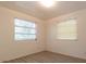 Bedroom with wood-look floors and two windows at 1068 North St, Daytona Beach, FL 32114