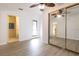 Bedroom with wood-look floors, mirrored closet and bathroom access at 1068 North St, Daytona Beach, FL 32114