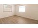 Simple bedroom with wood-look floors and two windows at 1068 North St, Daytona Beach, FL 32114