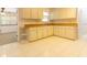 View of kitchen with white cabinets and a window at 1068 North St, Daytona Beach, FL 32114