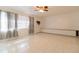 Spacious living room with tile floors and ceiling fan at 1068 North St, Daytona Beach, FL 32114