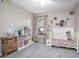 bedroom with a crib and plenty of storage at 1347 Pup Fish Ln, Deland, FL 32724