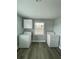 Bright laundry room, featuring washer, dryer, and overhead cabinets at 1631 Granada Ave, Daytona Beach, FL 32117