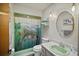 Bathroom with a green sink, shower, and unique fish-themed shower curtain at 1639 Templewood Ave, Deltona, FL 32725