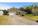 Brick ranch house with a carport, well-maintained lawn, and mature trees at 1639 Templewood Ave, Deltona, FL 32725