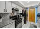 Kitchen with gray countertops, stainless steel appliances, and a black refrigerator at 1639 Templewood Ave, Deltona, FL 32725