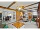 Open concept living space with exposed beams, a view of the dining area and kitchen at 1639 Templewood Ave, Deltona, FL 32725