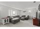 Spacious living room with gray sectional sofa and gray carpet at 1639 Templewood Ave, Deltona, FL 32725