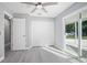 Bright bedroom with double door closet, wood-look floors, and sliding glass doors to backyard at 1661 Bismarck Dr, Deltona, FL 32725