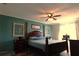 Main bedroom with a ceiling fan and teal walls at 1831 Trumbull St, Deltona, FL 32725