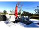 Outdoor patio dining area with red umbrella at 1831 Trumbull St, Deltona, FL 32725