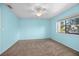 Light blue bedroom with neutral carpet and ceiling fan at 2 Fair Oaks Cir, Ormond Beach, FL 32174