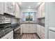 Well-equipped kitchen with granite counters and white cabinets at 2 Fair Oaks Cir, Ormond Beach, FL 32174