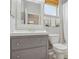 Clean bathroom with gray vanity, white toilet and bathtub at 201 W Chancery Ln, Deland, FL 32724