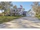 Two-story house with a large front yard, double garage, and a basketball hoop at 2236 River Ridge Rd, Deland, FL 32720