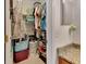 Bathroom closet with shelving and various clothing items at 2585 Delbarton Ave, Deltona, FL 32725