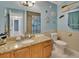 Bathroom with granite countertop, wood cabinets, and nautical theme at 2585 Delbarton Ave, Deltona, FL 32725